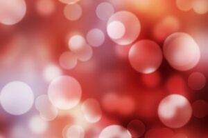 A dynamic red bokeh background with bright circles and blurred patterns.