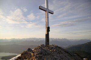 Panoramic alpine scenery with a cross on the summit in Garmisch-Partenkirchen, Germany.